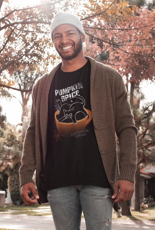 Man wearing a black t-shirt with 'Pumpkin Spice' graphic and a brown cardigan outdoors.